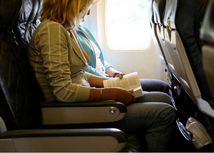 woman reading on an airplane